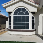 arched and square windows black solar screens white frames