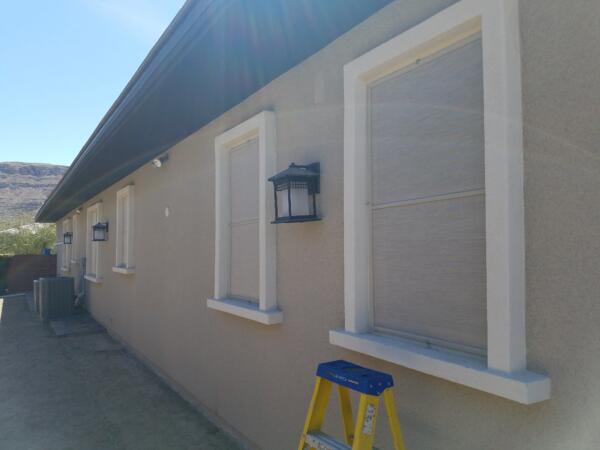 Stucco sun screens for daytime privacy on first floor windows in Henderson, NV.